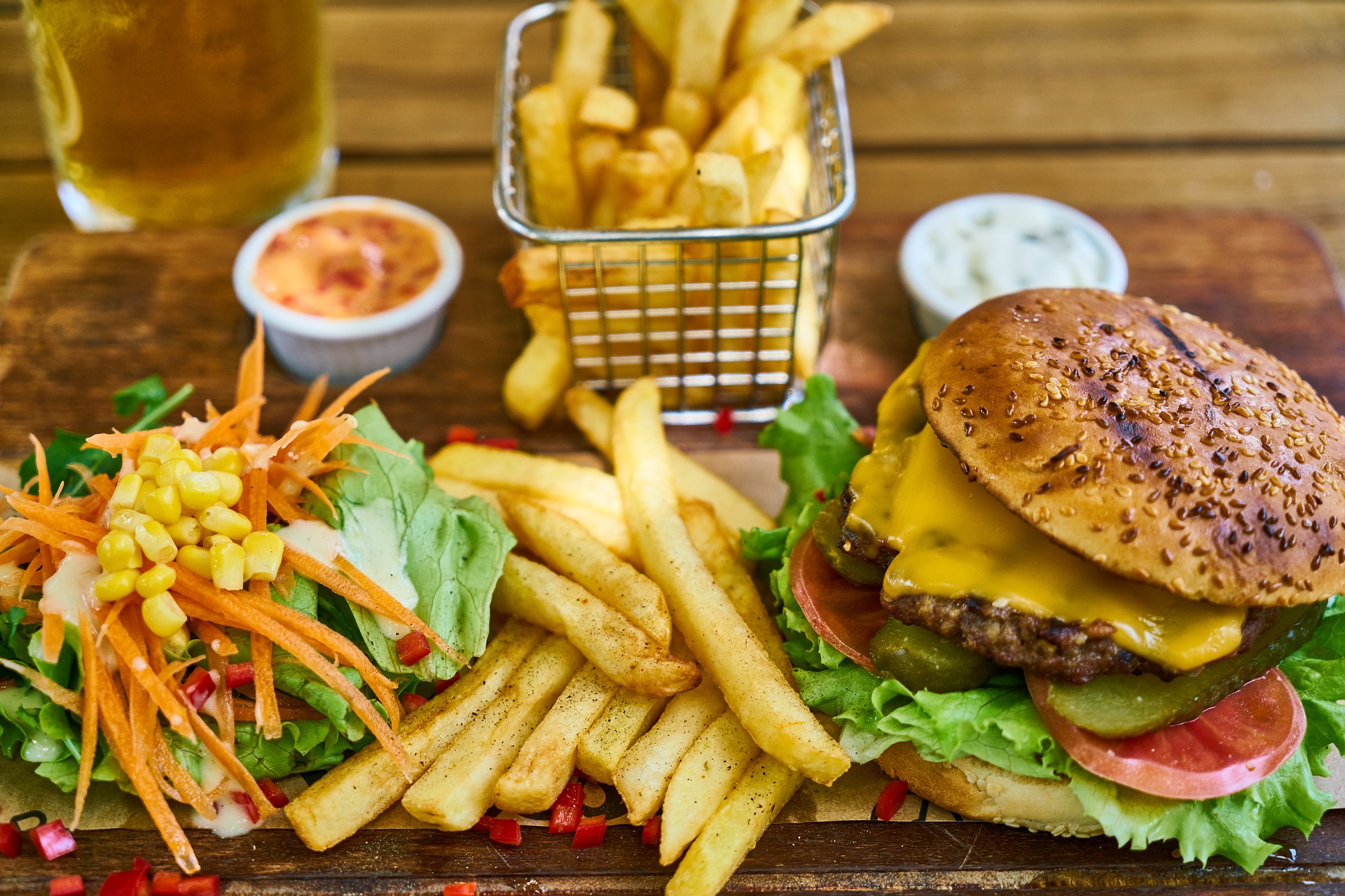 A cheeseburger, fries and a salad