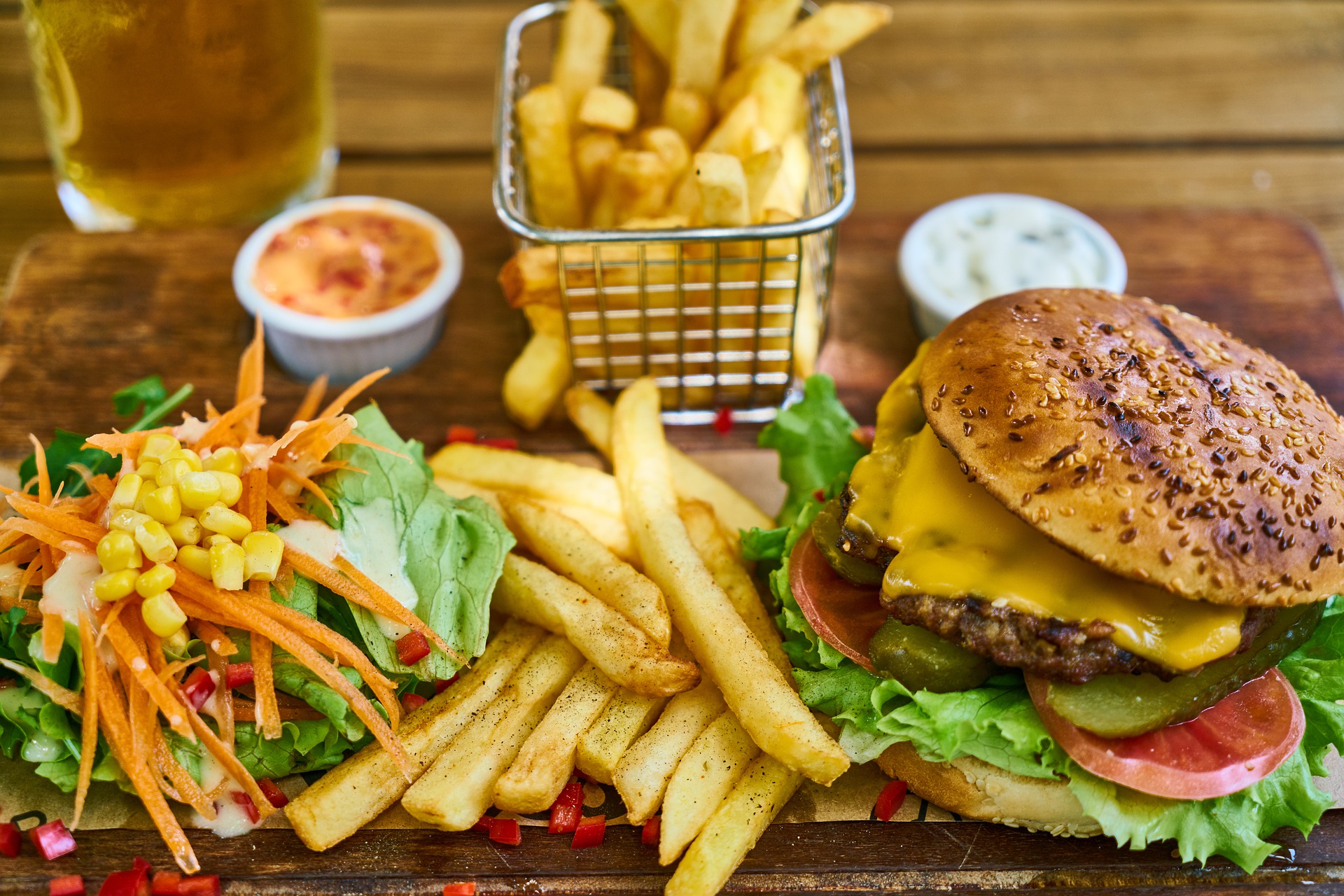 A cheeseburger, fries and a salad 