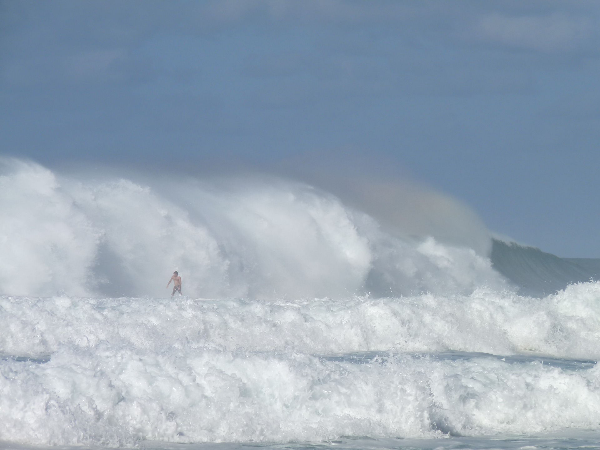 Surfer on massive North Shore waves on Oahu 