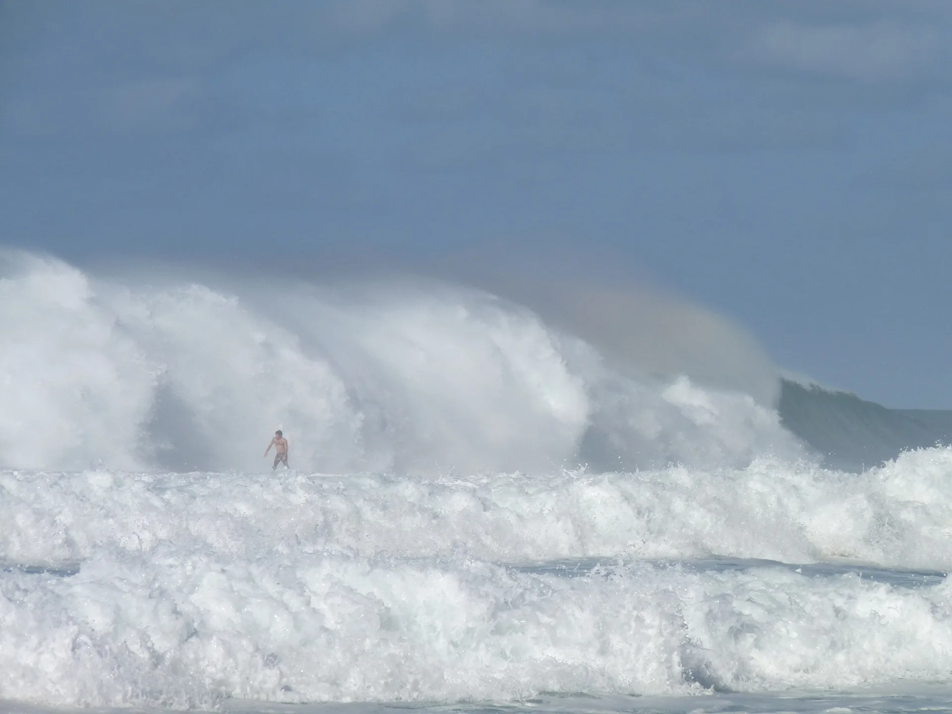 Surfer on massive North Shore waves on Oahu