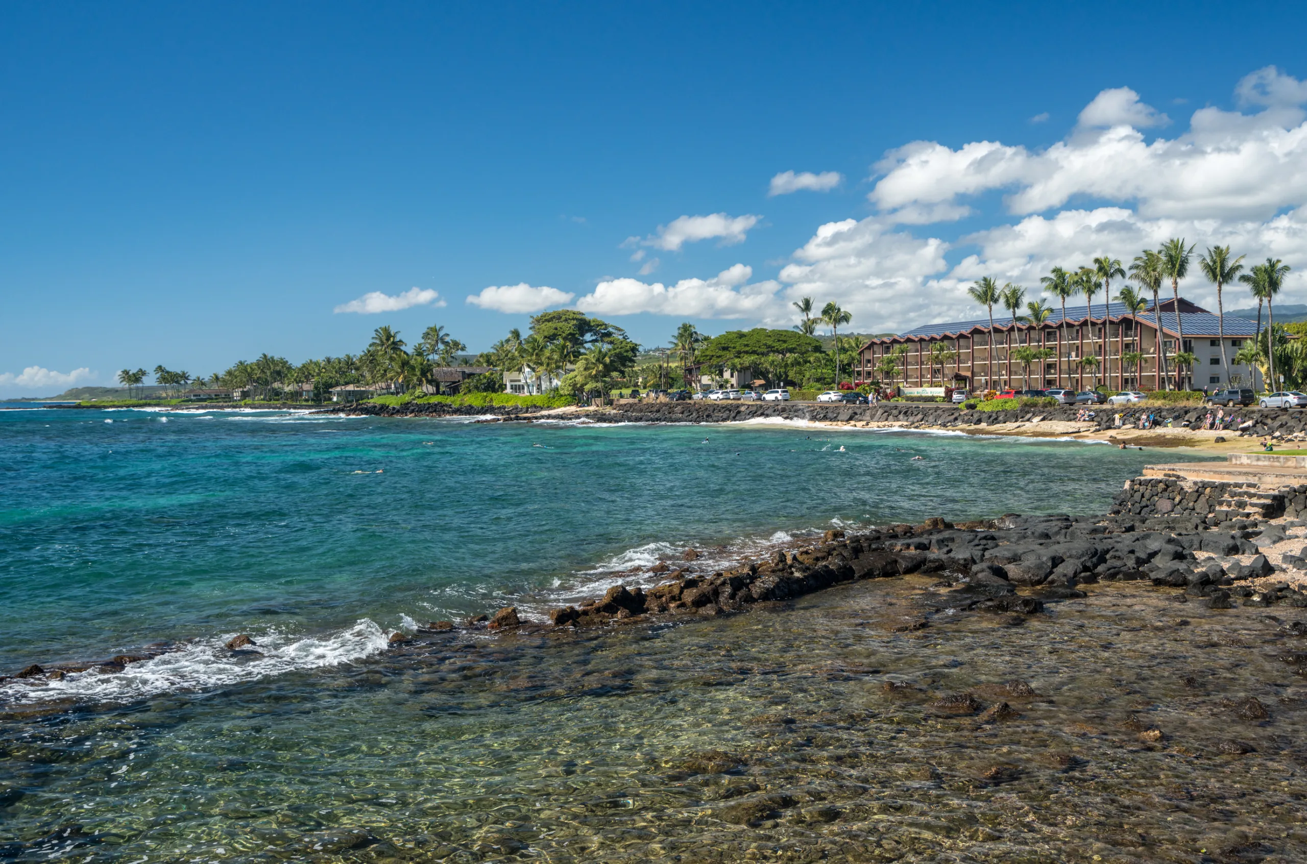 Lawai Beach on Kauai’s south shore with lava rock shoreline and calm ocean conditions